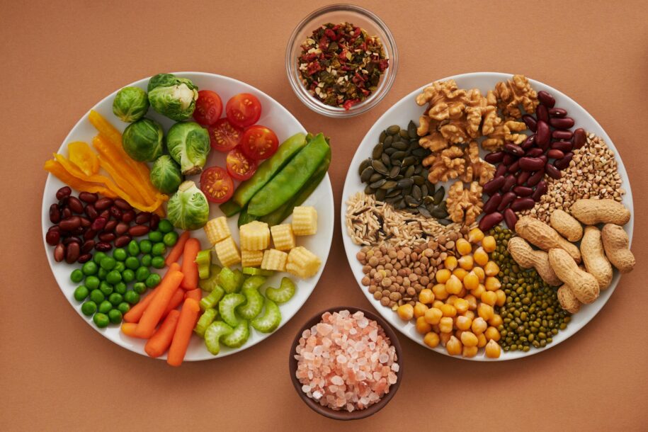 Vibrant display of assorted vegetables, legumes, nuts, and seeds on plates, perfect for healthy eating images.